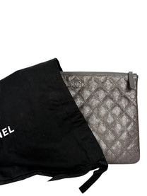 Chanel Medium O-Case in quilted camellia-embossed leather