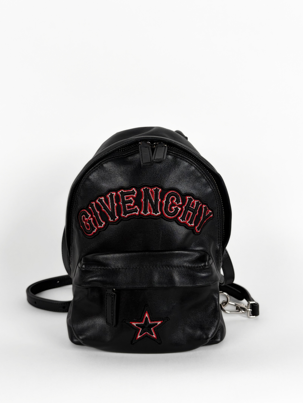Black Givenchy backpack with red text and star on a white background